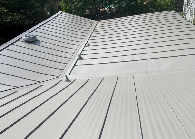 Solar attic fan installed on a metal roof for Roof Ventilation in Lakehills